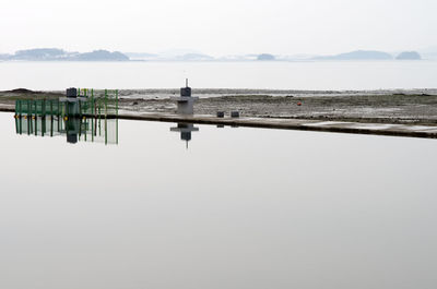 Pier over lake against sky