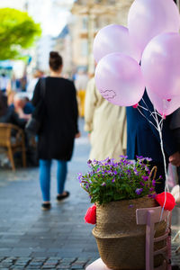 Rear view of people with pink balloons