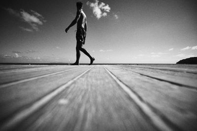 Low section of person walking on swimming pool