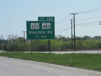 Road sign against sky