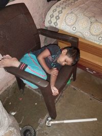 High angle view of girl sitting on floor