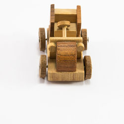 Close-up of wooden toy vehicle against white background