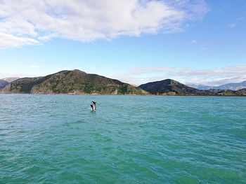 Scenic view of sea and mountains against sky