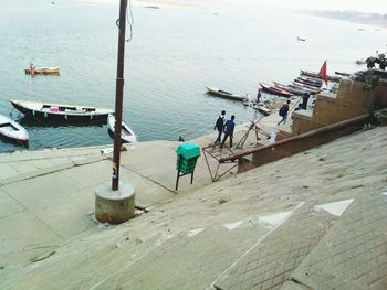 High angle view of people working in sea