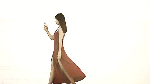 Low angle view of woman standing against sky