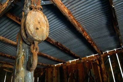 Low angle view of rusty hanging on wood