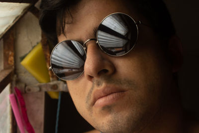 Close-up portrait of young man wearing sunglasses