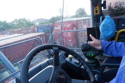 Man taking selfie in city seen through windshield