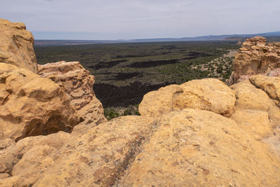 Scenic view of rocky mountains and sea against sky