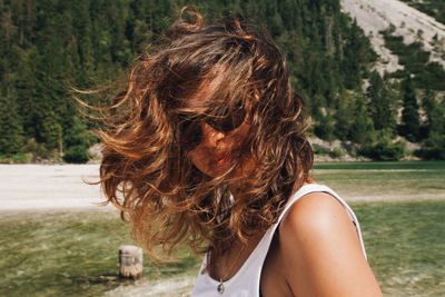 Rear view of woman with palm leaf