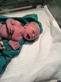 High angle view of newborn baby girl in incubator at hospital