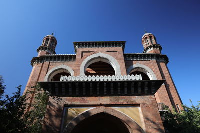 Low angle view of historical building against clear blue sky