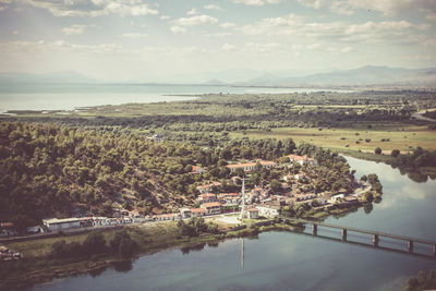 High angle view of townscape by sea against sky