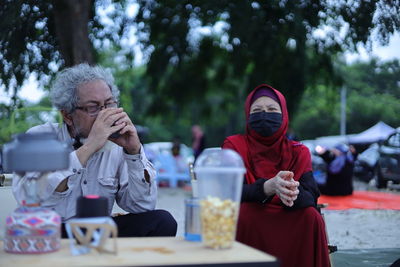 Full length of a man drinking glass on table