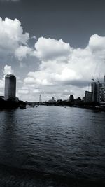 City by river against sky