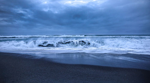 Scenic view of sea waves against sky