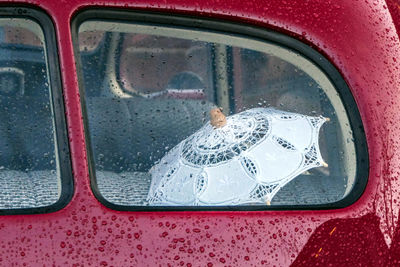 Reflection of car on wet window