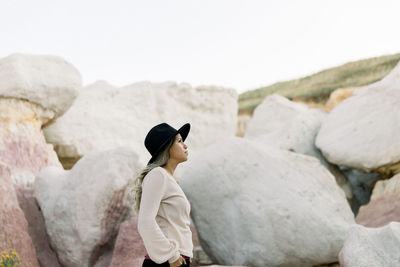 Portrait of woman looking off into the distance in between rocks