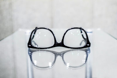 Close-up of eyeglasses on glass table