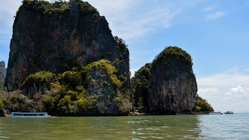 Scenic view of rock formation in sea against sky