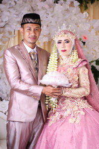 Portrait of young couple during wedding ceremony