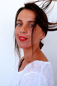 Portrait of smiling young woman against white background