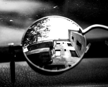 Close-up of sunglasses on side-view mirror