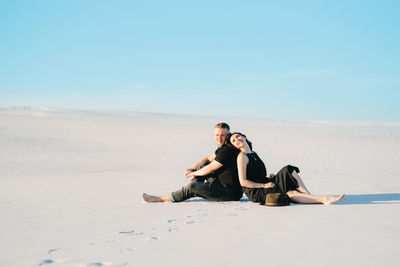 Young couple sitting on beach