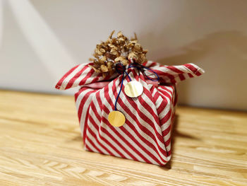 Close-up of red wrapped in box on table