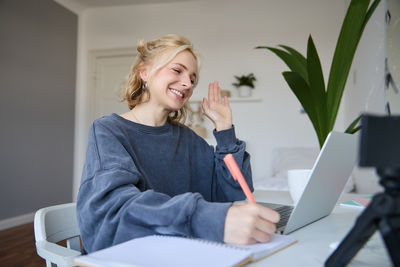 Portrait of young woman reading book