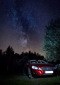 Cars parked on road at night
