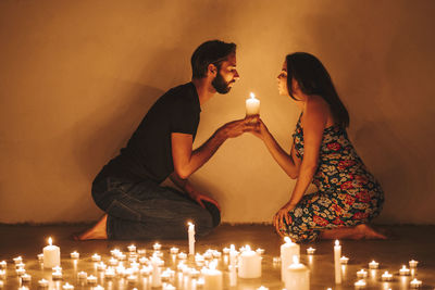 Friends enjoying illuminated candles