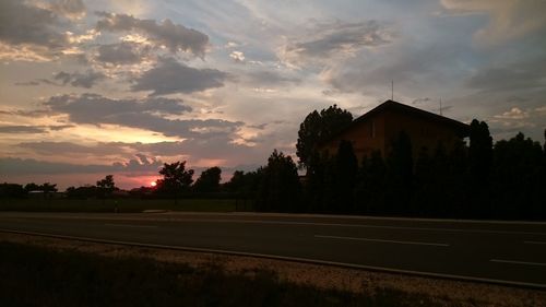 Road against cloudy sky at sunset