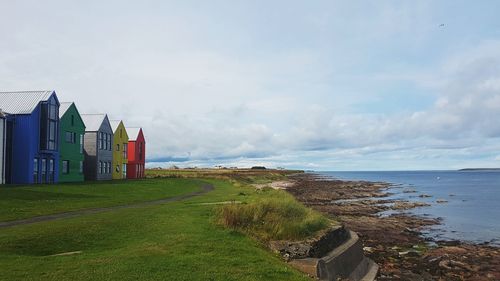 Scenic view of sea against buildings
