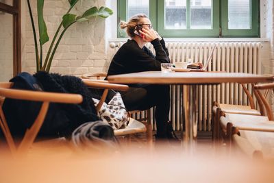 Woman sitting on mobile phone