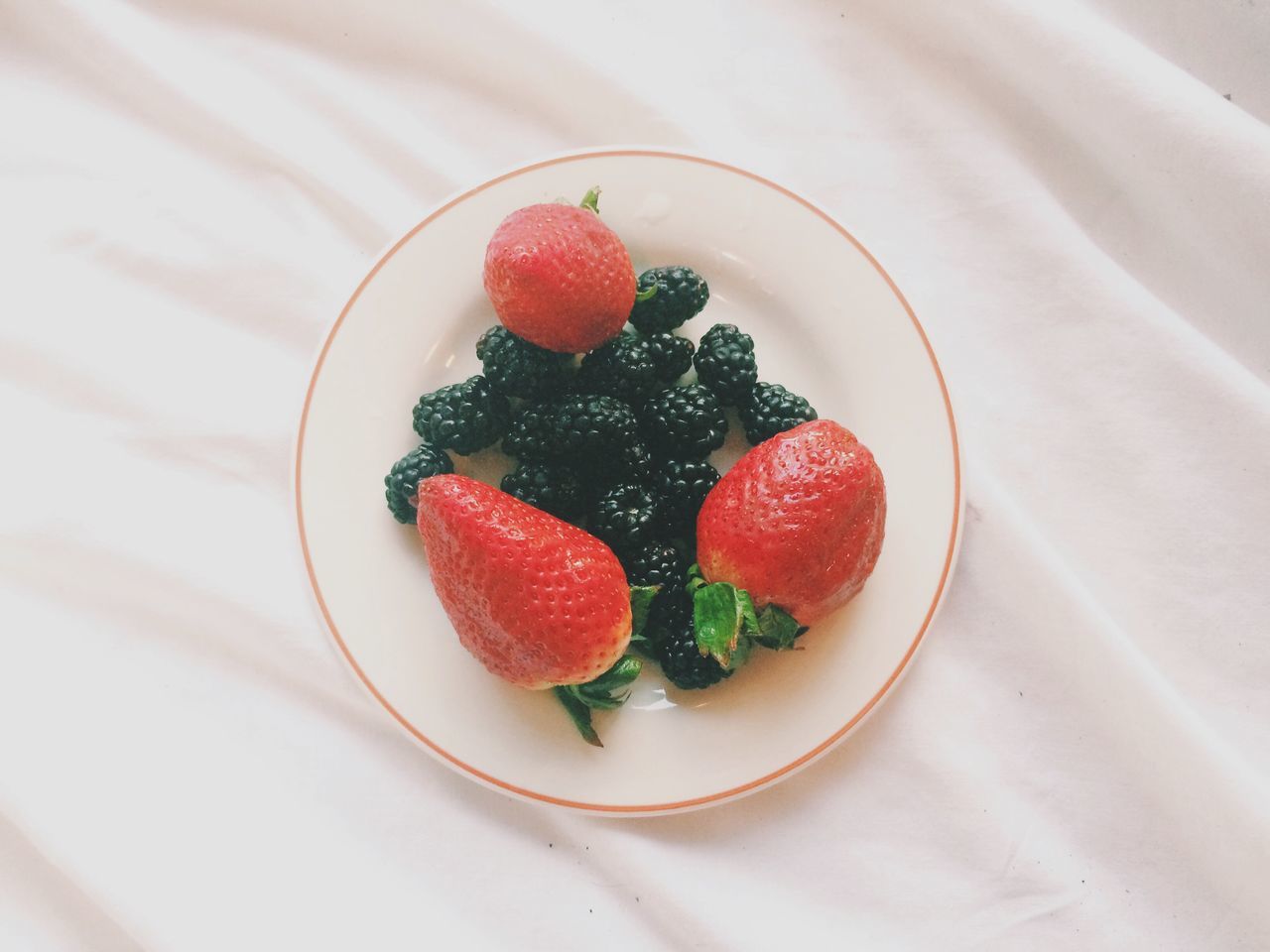 food and drink, food, indoors, freshness, strawberry, fruit, healthy eating, red, plate, ready-to-eat, still life, table, berry fruit, indulgence, bowl, sweet food, close-up, high angle view, raspberry, serving size