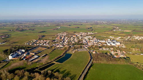 High angle view of buildings on field against sky