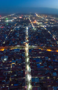 Aerial view of illuminated cityscape at night