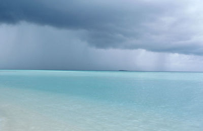 Scenic view of sea against storm clouds