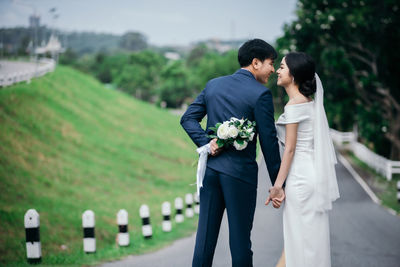 Rear view of couple kissing against blurred background