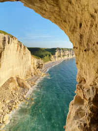 High angle view of rock formations blow hole cave blue water beach etretat cliff clear sky sunny day 