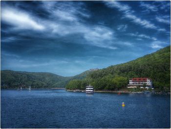 Scenic view of lake against cloudy sky