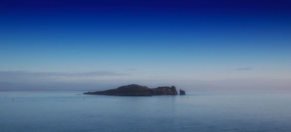 Scenic view of sea against blue sky