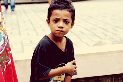 Portrait of boy standing outdoors