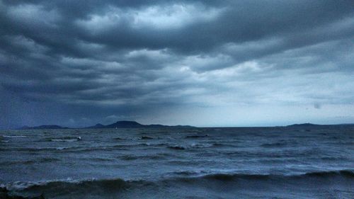 Scenic view of sea against storm clouds