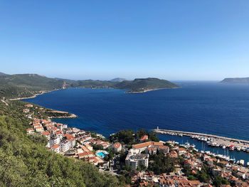 High angle view of townscape by sea against clear sky