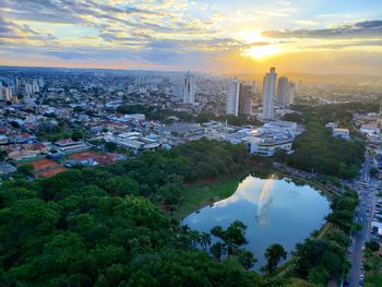 High angle view of city buildings against sky during sunset