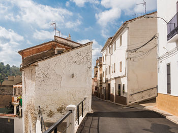 Alley amidst buildings against sky
