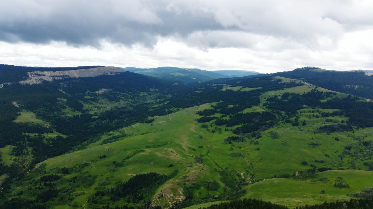 mountain, sky, tranquil scene, tranquility, scenics, mountain range, green color, beauty in nature, cloud - sky, landscape, nature, cloudy, tree, lush foliage, growth, cloud, non-urban scene, idyllic, valley, green