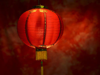 Close-up of illuminated lantern hanging against wall